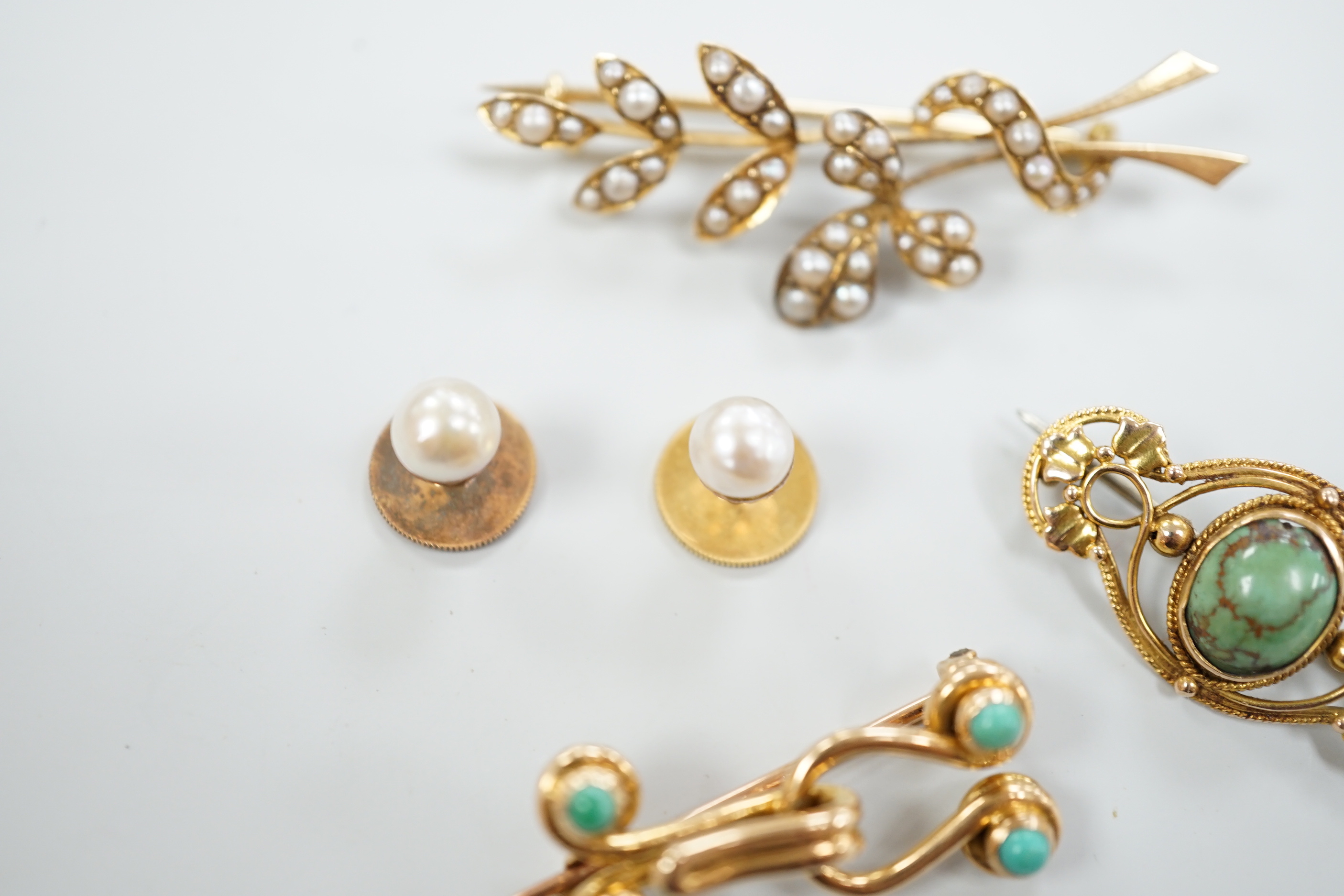 An Edwardian 15ct and seed pearl cluster set spray brooch, 47mm, a 15ct and four stone turquoise set brooch, one other yellow meta and turquoise brooch and a pair of 9ct and cultured pearl set dress studs.